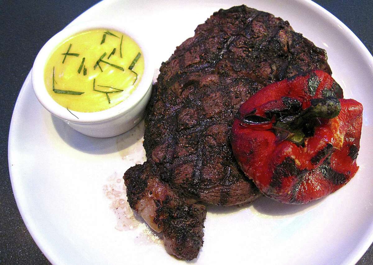 Grilled rib-eye steak with a roasted red pepper and a side of bearnaise from Rebelle.