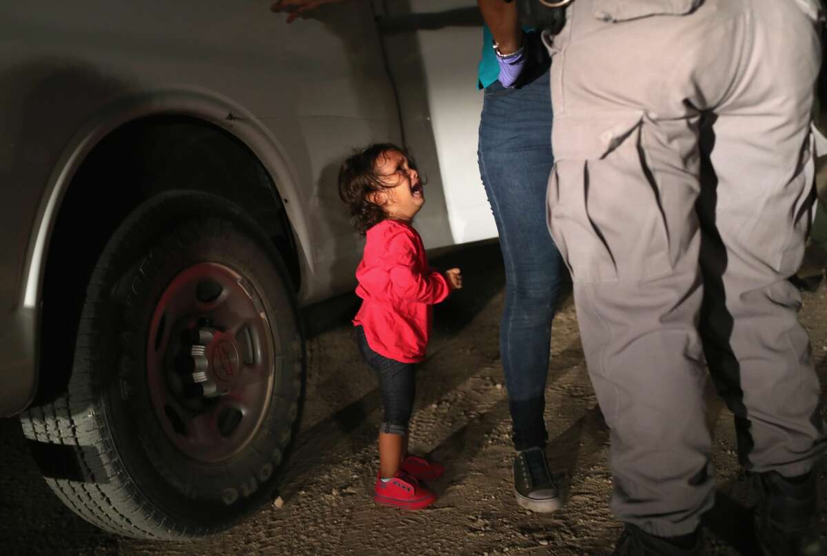 A two-year-old Honduran asylum seeker cries as her mother is searched and detained near the U.S.-Mexico border on June 12, 2018 in McAllen, Texas. The asylum seekers had rafted across the Rio Grande from Mexico and were detained by U.S. Border Patrol agents before being sent to a processing center for possible separation. See photos of U.S. Border Patrol working along the U.S.-Mexico border earlier this year ...