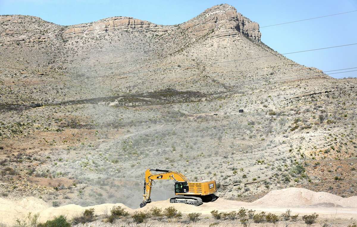 Earth moving equipment spreads dirt over the Trans-Pecos Pipeline near Presidio, TX.
