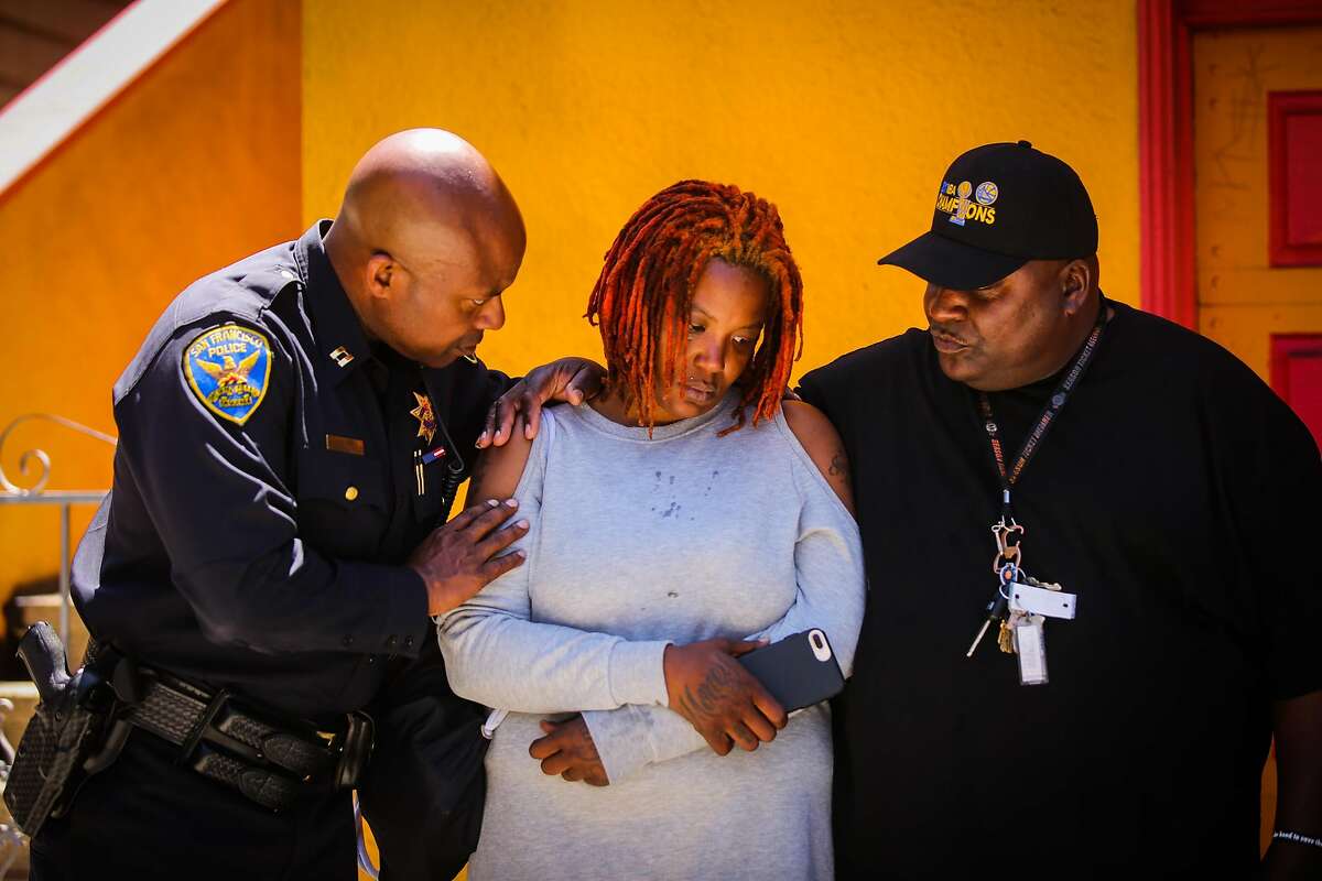 Bayview Station Capt. Steven Ford (left) comforts Sarah Inez Thomas-Cael, the wife of Jevon Cael who was killed last Monday in the Bayview during a prayer service in the Bayview in San Francisco, California, on Monday, June 11, 2018.