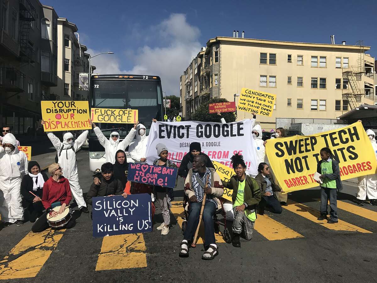 Anti-displacement posters block a Google shuttle bus on May 31, 2018 at the corner of 24th and Valencia in San Francisco, Calif.