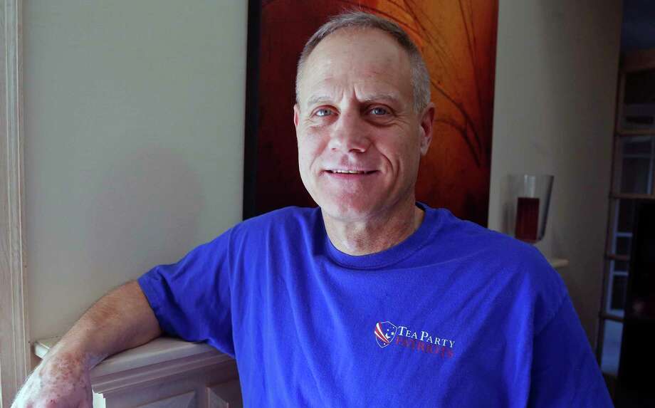 FILE - In this Feb. 16, 2018, photo, Andy Cilek poses with a Tea Party shirt at his home in Eden Prairie, Minn. Cilek was one of two voters who defied elections officials after he was asked to cover up a tea-party shirt and button. The Supreme Court has struck down a Minnesota law that restricted what voters can wear to polls. The justices ruled June 14,  that the law violates the First Amendment. Still, the justices 7-2 ruling suggested that some restrictions on what people can wear to vote are permissible. (AP Photo/Jim Mone, File) Photo: Jim Mone / Copyright 2018 The Associated Press. All rights reserved.