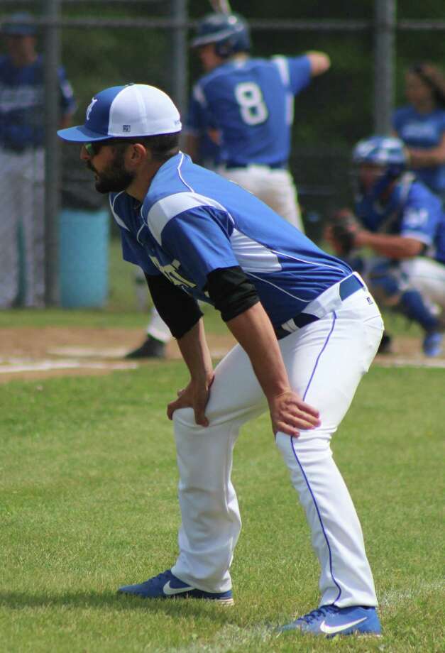 Abbott Tech baseball coach David Simone surveys the action as Daniel Collinge (8) steps into the batter's box during the Class M state baseball tournament quarterfinal game against Lewis Mills at Lewis Mills High School June 3, 2017. Photo: Richard Gregory / Richard Gregory