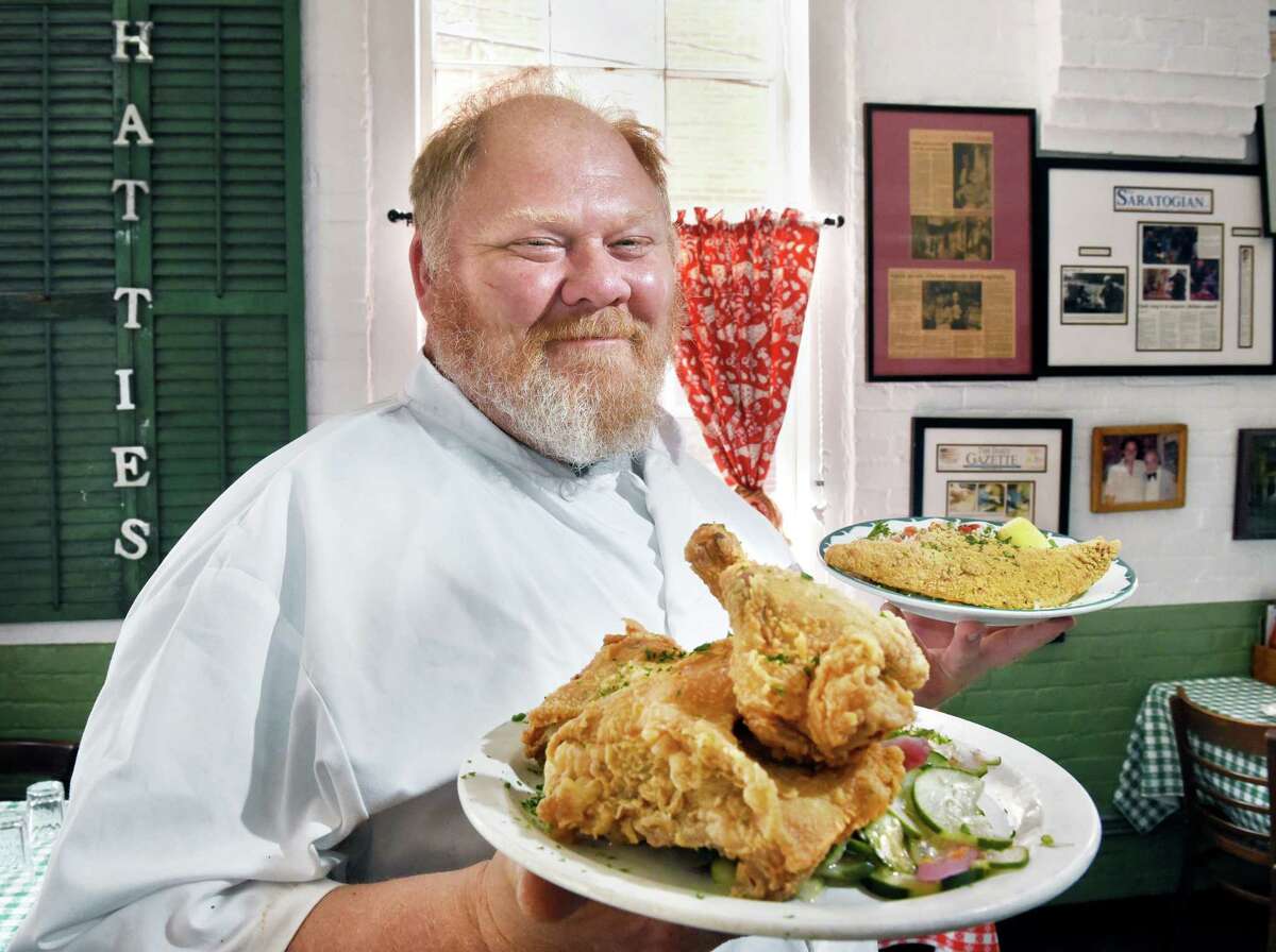 Chef Jasper Alexander with dishes of their signature fried chicken and fried catfish at Hattie's Restaurant on Phila Street Wednesday June 6, 2018 in Saratoga Springs, NY. (John Carl D'Annibale/Times Union)