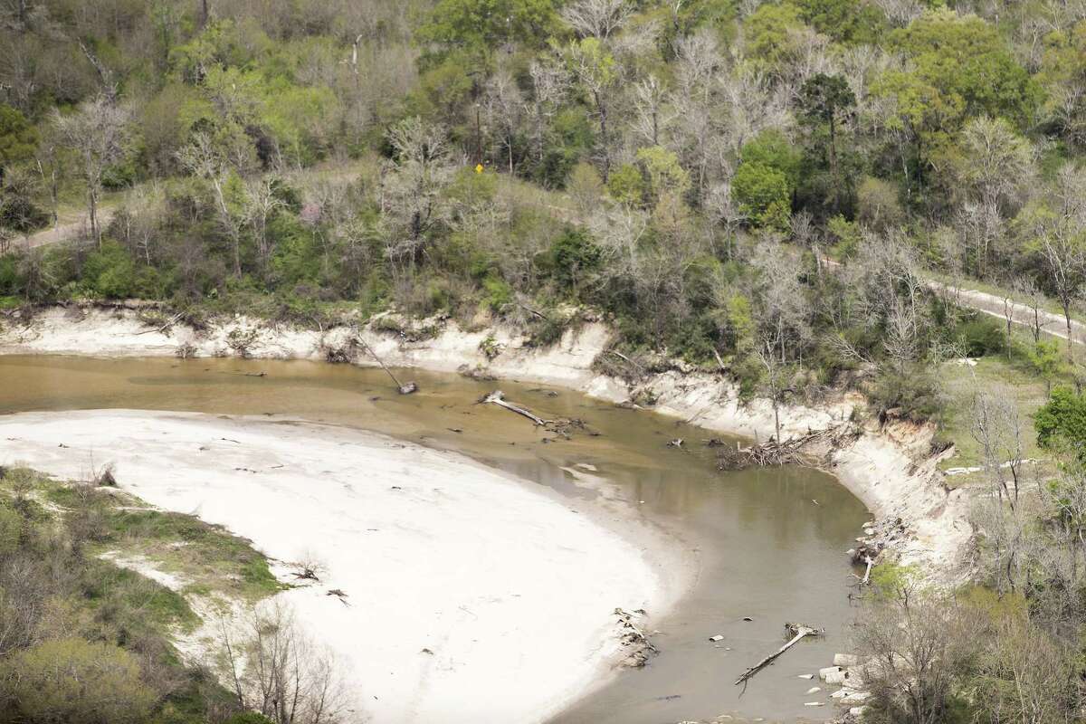 Sand is piled up along the banks of the San Jacinto River, downstream from Lake Conroe, on Thursday, March 15, 2018, in Houston. The Kingwood area suffered serious flooding during Hurricane Harvey due in part to sand washed downstream from sand mining operations along the river.