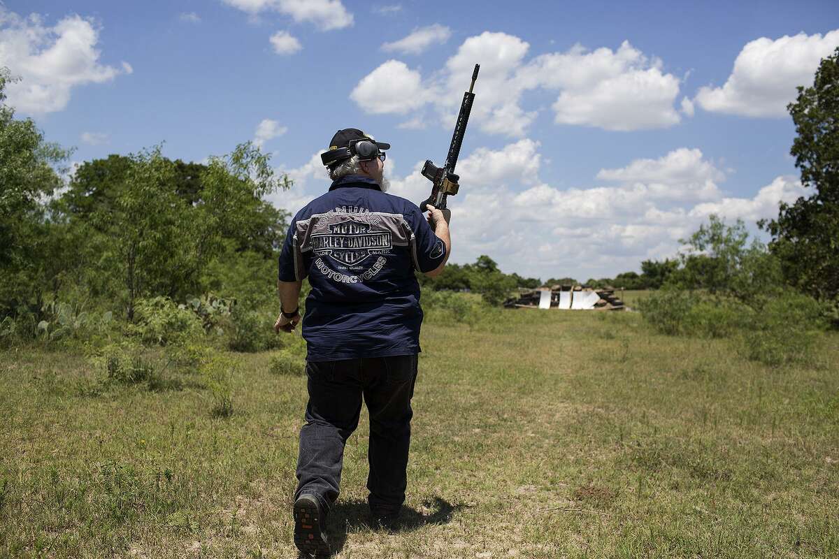 Stephen Willeford walks to shoot an AR-15 rifle specially made for him and gifted to him moments earlier by Stephen Oliver, a firearms manufacturer and dealer with Texas Rifle, for the first time at Willeford's property near Sutherland Springs on May 28, 2018.