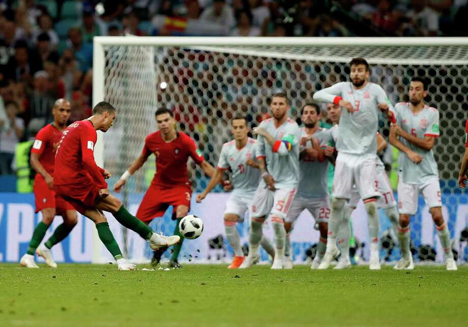 Portugal's Cristiano Ronaldo, left, scores his side's equalizing goal during the group B match between Portugal and Spain at the 2018 soccer World Cup in the Fisht Stadium in Sochi, Russia, Friday, June 15, 2018. (AP Photo/Francisco Seco) Photo: Francisco Seco / Copyright 2018 The Associated Press. All rights reserved.