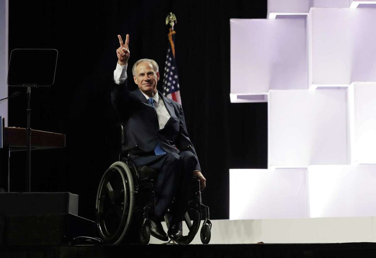 Gov. Greg Abbott waves to delegates at the Texas GOP Convention in San Antonio on June 15.
