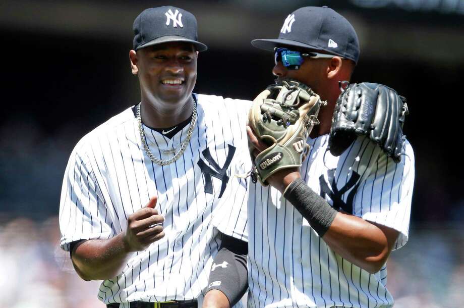 New York Yankees pitcher Luis Severino, left, laughs with third baseman Miguel Andujar as they walk back to the dugout during the first inning of a baseball game against the Tampa Bay Rays on Saturday, June 16, 2018, in New York. (AP Photo/Adam Hunger) Photo: Adam Hunger / FR110666 AP