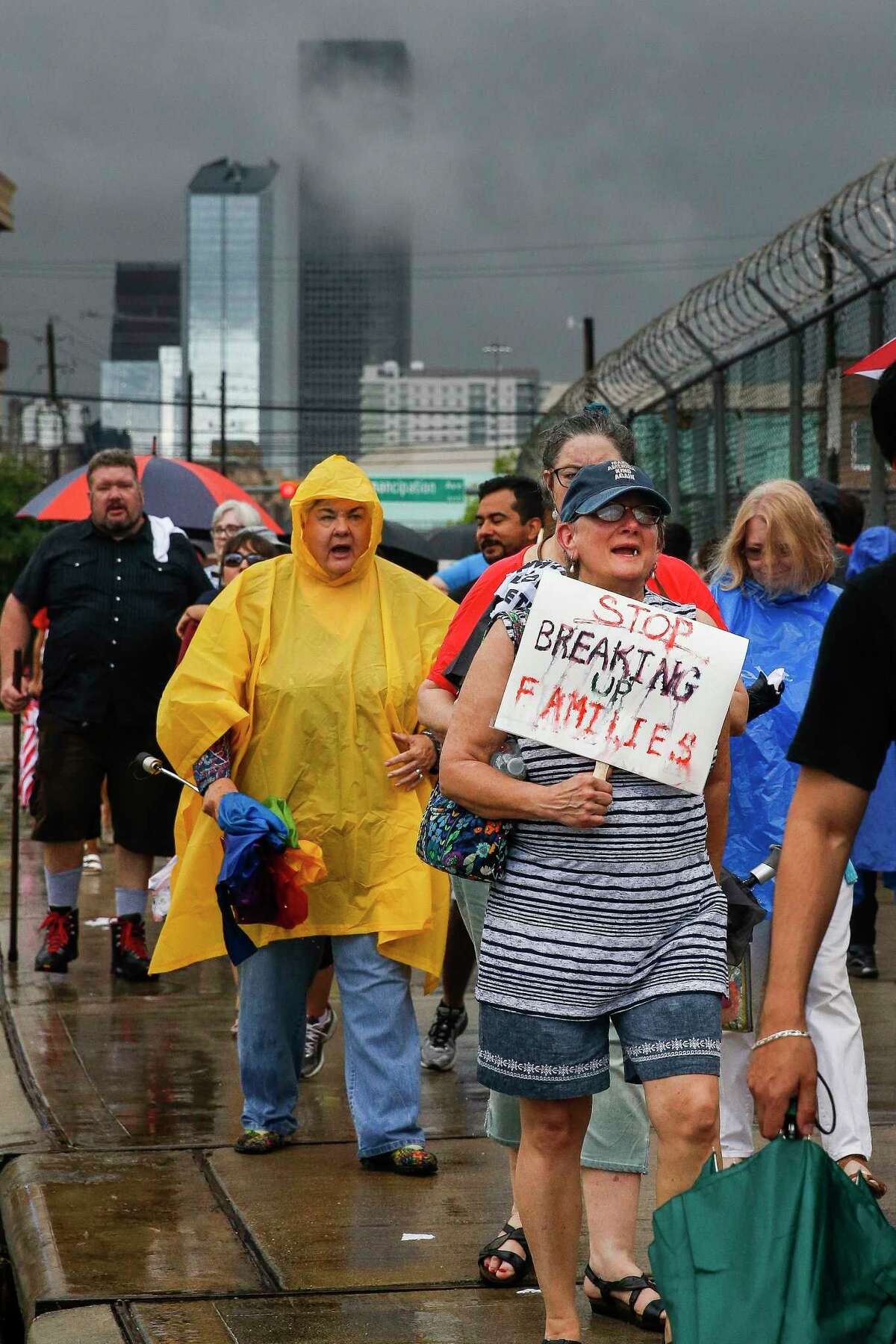 Protesters march during a Families Belong Together prayer vigil outside a facility near downtown Houston that has been leased to house unaccompanied immigrant children Sunday, June 17, 2018.