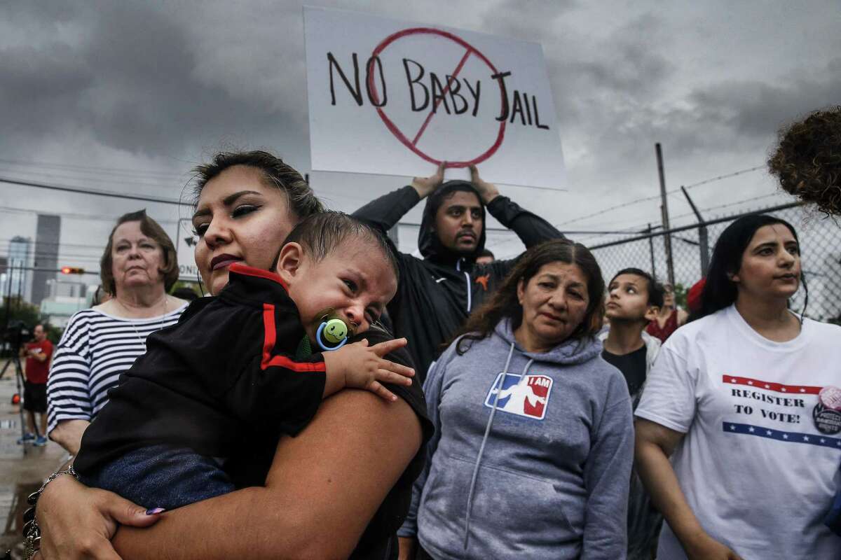 Aura Fernandez, left, holds her crying son, Leonardo Fernandez, 1, as protesters gather for a Families Belong Together prayer vigil outside a facility near downtown Houston that has been leased to house unaccompanied immigrant children Sunday, June 17, 2018. (Michael Ciaglo / Houston Chronicle)