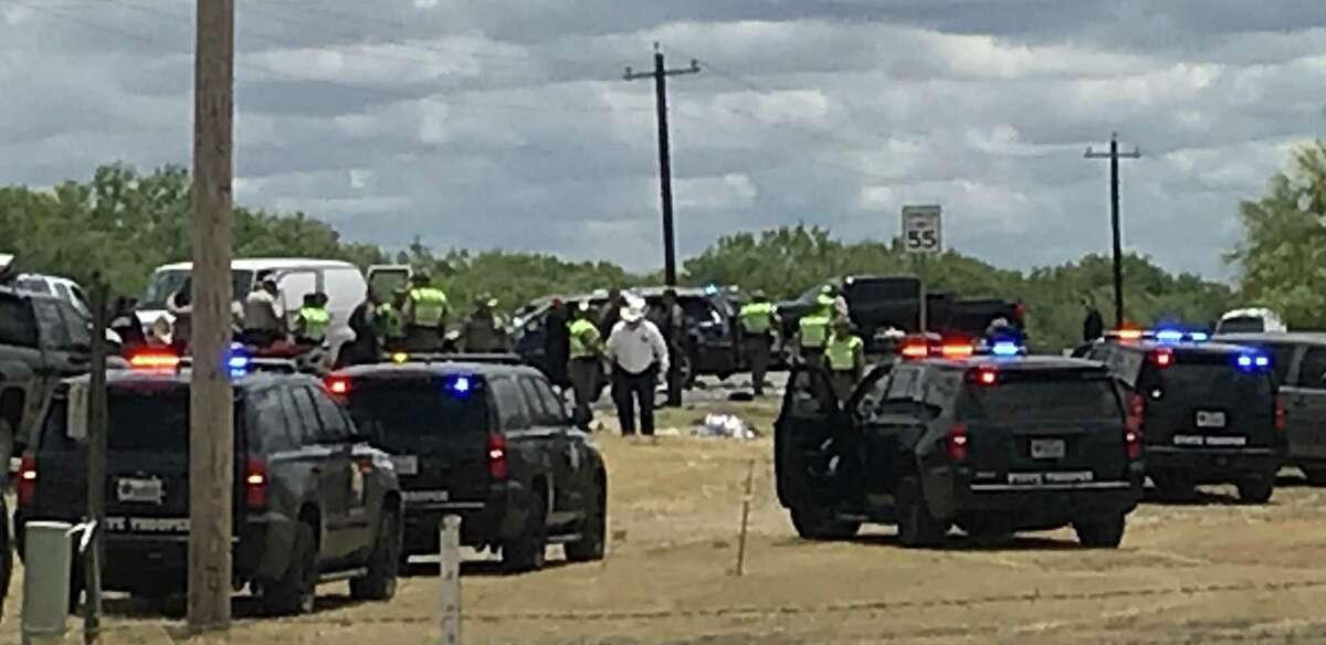 Law enforcement personnel work the scene of a rollover accident of an SUV that was carrying illegal immigrants along Texas Highway 85 in Big Wells, Texas, on Sunday, June 17, 2018. Five people died as a result of the crash.