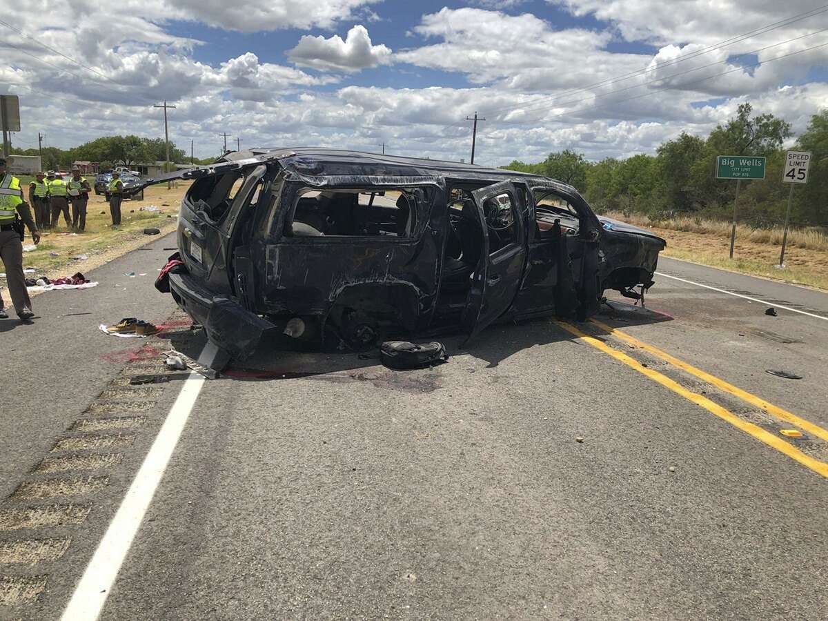In this image tweeted by David Caltabiano of KABB/WOAI, a heavily damaged SUV is seen on Texas Highway 85 in Big Wells, Texas, after crashing while carrying more than a dozen people fleeing from Border Patrol agents on Sunday