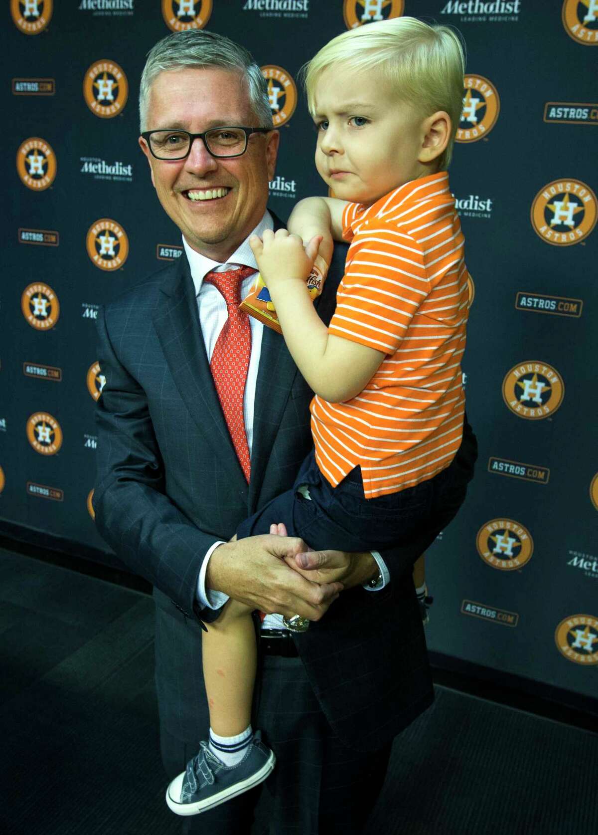Houston Astros' Jeff Luhnow embraces his son, Henry, following a news conference announcing that he has been named President of Baseball Operations and General Manager at Minute Maid Park on Monday, June 18, 2018, in Houston. Luhnow also was given a contract extension throug thge 2023 season.