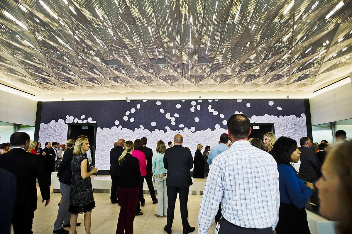 Dow employees get their first look at the new Andrew N. Liveris Visitors and Heritage Center, which features a wall covered in a moving screen displaying current facts about the company, on Monday, June 18, 2018 at the company's Midland corporate headquarters. The 19,100 square foot visitor center is closed to the general public, but will be a useful addition to welcome employees, customers and visitors to the company, said Rachelle Schikorra, Dow spokesperson. (Katy Kildee/kkildee@mdn.net)