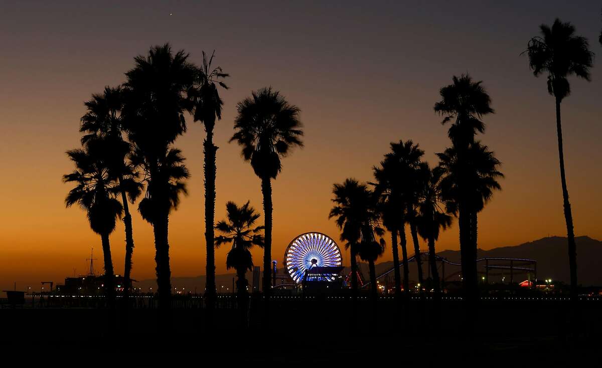 FILE - In this Oct. 11, 2013 file photo, the Ferris wheel at Pacific Park on the Santa Monica Pier is illuminated in Santa Monica, Calif. The relocation of tech companies to southern California is part of a growing movement of U.S. cities seeking to duplicate the formula that turned northern California�s Silicon Valley, slightly south of San Francisco, into a mecca of society-shifting innovation and immense wealth. (AP Photo/Mark J. Terrill, File)