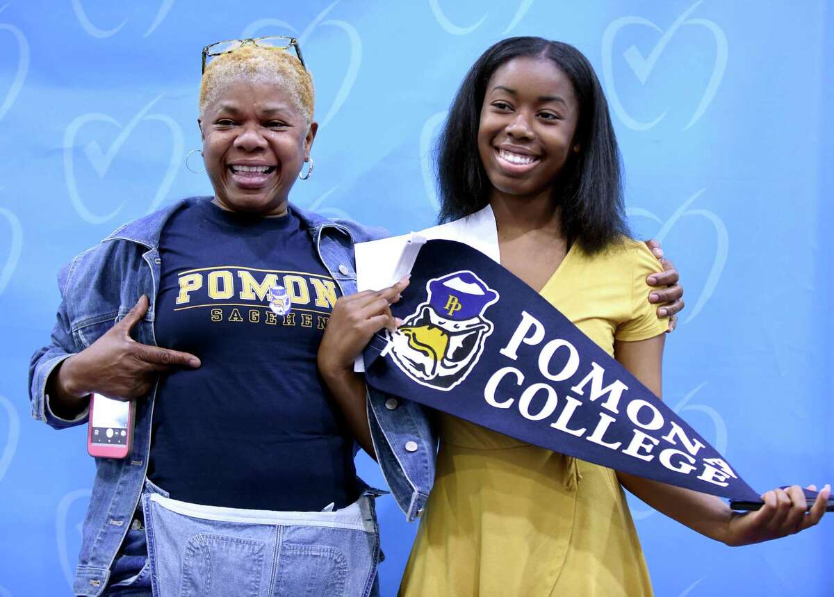 Sonia Rochester (left) celebrates with her daughter, Nia Anderson, who announced she will attend Pomona College in the fall during Senior Signing Day at Achievement First Amistad High School in New Haven on May 24, 2018.