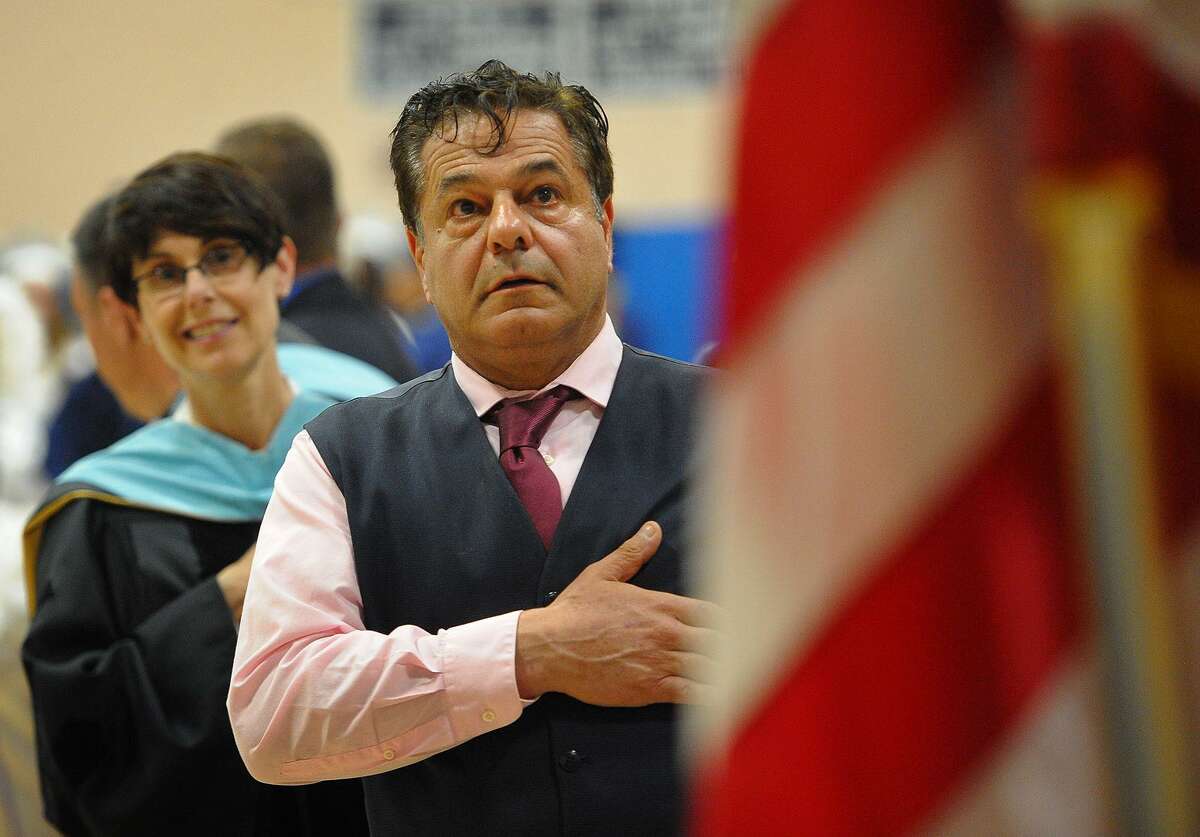 Ansonia Superintendent of Schools Carol Merlone, left, and Mayor David Cassetti during the singing of the National Anthem at the Ansonia High School Commencement on Monday.