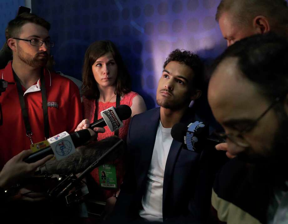 FILE - In this May 18, 2018, file photo, Trae Young, center, from Oklahoma, listens to a question during the interview segment of the NBA draft basketball combine, in Chicago. Most of the furniture was taken out of several rooms on the 15th and 16th floor of the hotel in downtown Chicago. There's a couple tables, a few chairs, and when the doors open to those suites draft hopefuls can make or break their futures in 20 minutes. This is where the interviews happen for the draft, where teams meet players and ask them about everything from their family histories to their thoughts on highway safety before investing millions of dollars. (AP Photo/Charles Rex Arbogast, File) Photo: Charles Rex Arbogast / Copyright 2018 The Associated Press. All rights reserved.