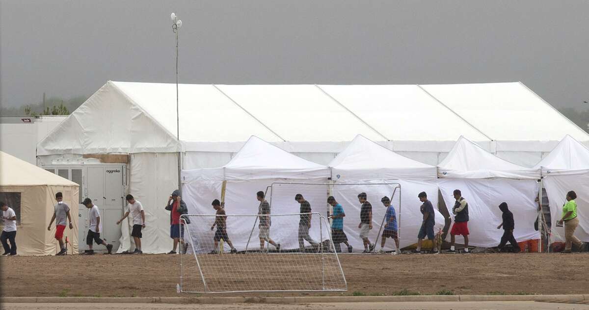 Immigrant kids walk through the C.B.P. facility where the newly formed "tent city" is located, Saturday, June 16, 2018, in Tornillo. Photo by Ivan Pierre Aguirre/ for the San Antonio Express-News