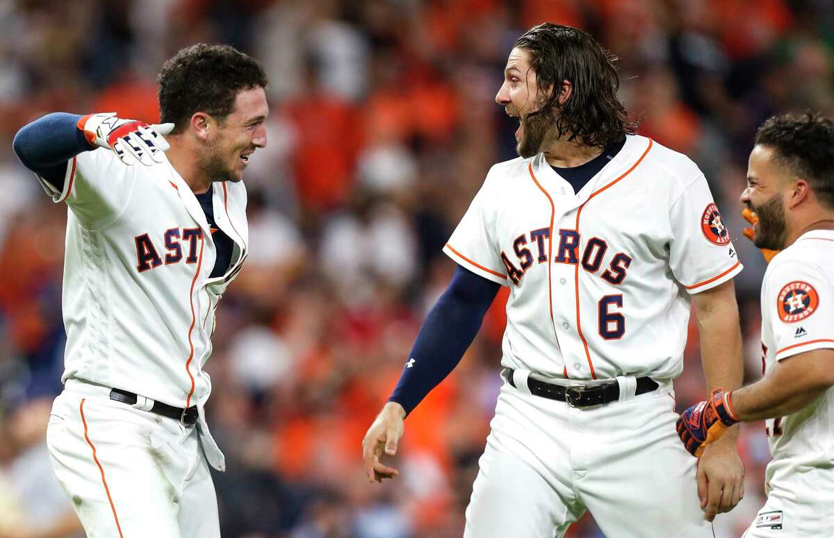 Houston Astros third baseman Alex Bregman, left, Jake Marisnick (6) and Jose Altue celebrate Bregman's walkoff 2 RBI double against the Tampa Bay Rays during the ninth inning of a major league baseball game at Minute Maid Park on Monday, June 18, 2018, in Houston. The Astros came from behind to beat the Rays 5-4.