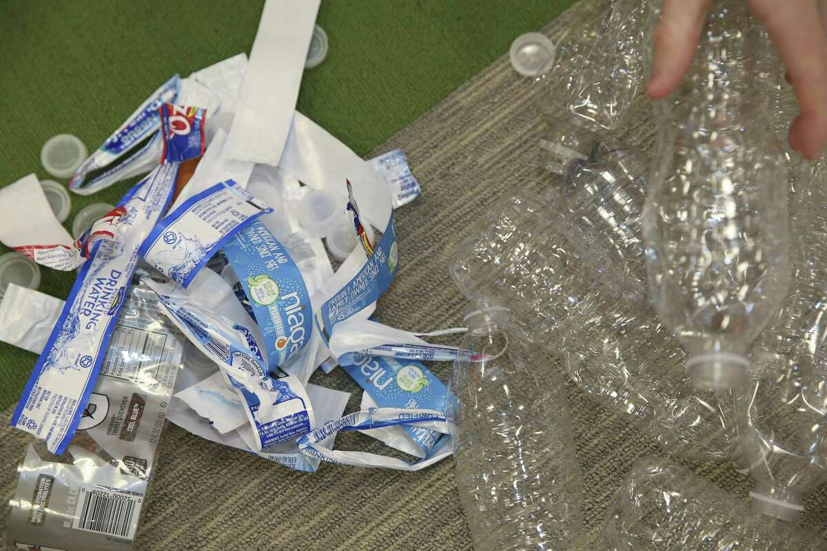 Living Word Lutheran Church High School Youth Group memers peel off labels and take off caps of plastic water bottles for an art installation project for a part of the upcoming Evangelical Lutheran Church in America's (ELCA) ELCA Youth Gathering on Friday, June 15, 2018, in Katy. The church collected over 2,000 plastic bottles from a drive in the span of roughly a month. More than 30,000 youth, adult leaders and others from the ELCA from all over the nation will participate in the ELCA Youth Gathering in Houston June 25-July 1. ( Yi-Chin Lee / Houston Chronicle )