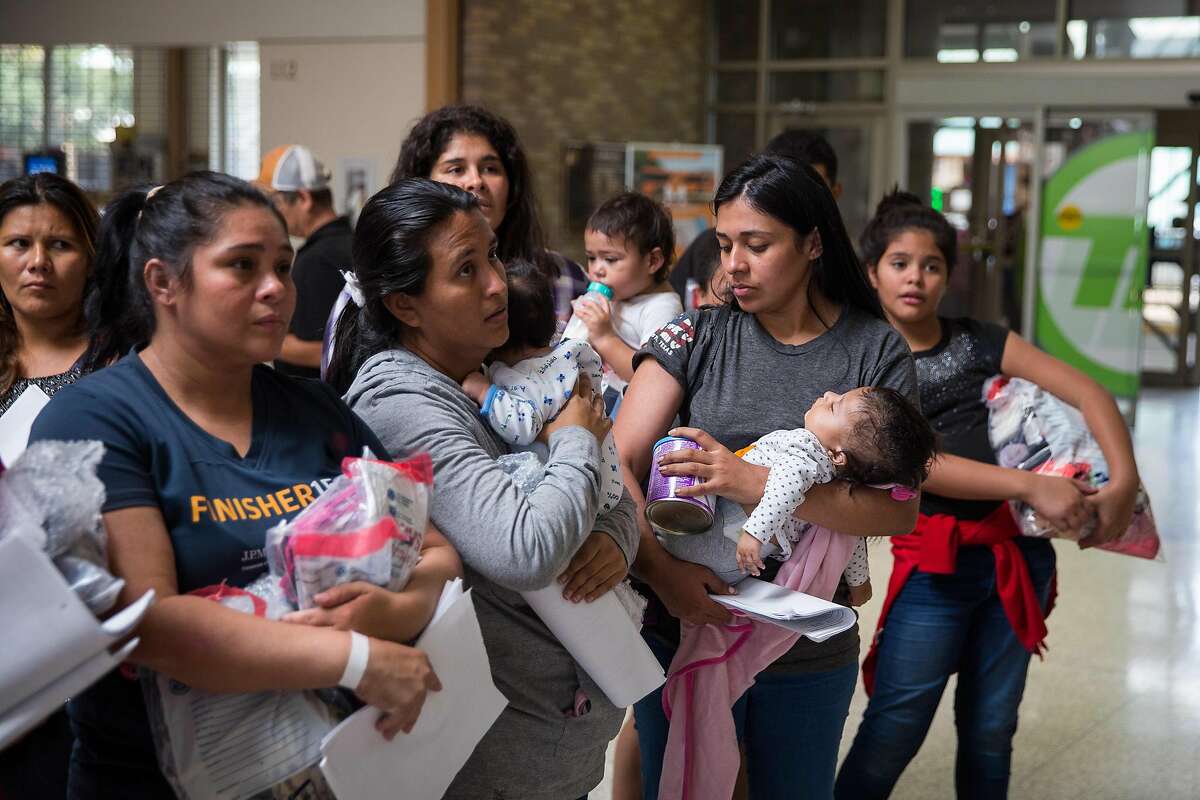 Immigrants wait to head to a nearby Catholic Charities relief center after being dropped off at a bus station shortly after release from detention through "catch and release" immigration policy on June 17, 2018 in McAllen, Texas. The man said he was separated from his son while in detention. "Catch and release" is a protocol under which people detained by US authorities as unlawful immigrants can be released while they wait for a hearing. / AFP PHOTO / Loren ELLIOTTLOREN ELLIOTT/AFP/Getty Images