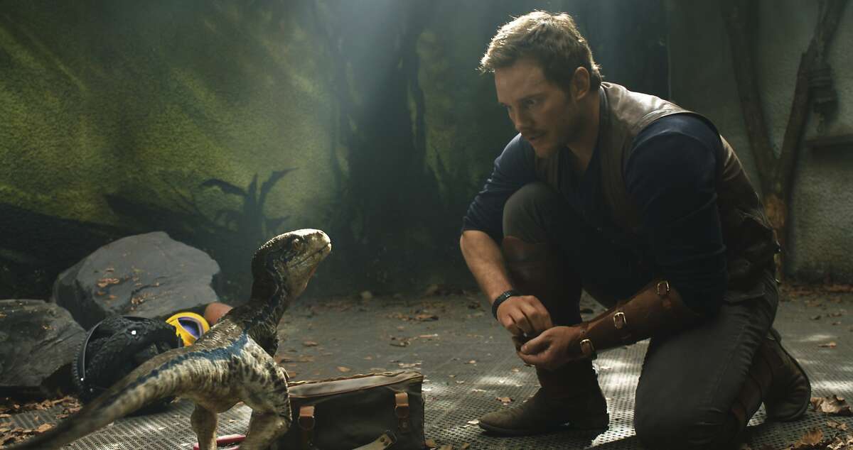 This image released by Universal Pictures shows Chris Pratt in a scene from the upcoming "Jurassic World: Fallen Kingdom." 