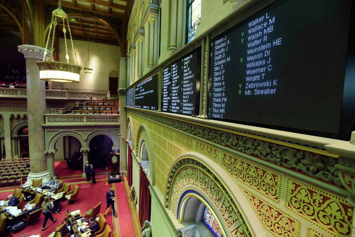 Names of members of the Assembly and how they are voting are seen on a board above the Assembly floor at the Capitol on Tuesday, June 19, 2018, in Albany, N.Y. (Paul Buckowski/Times Union)
