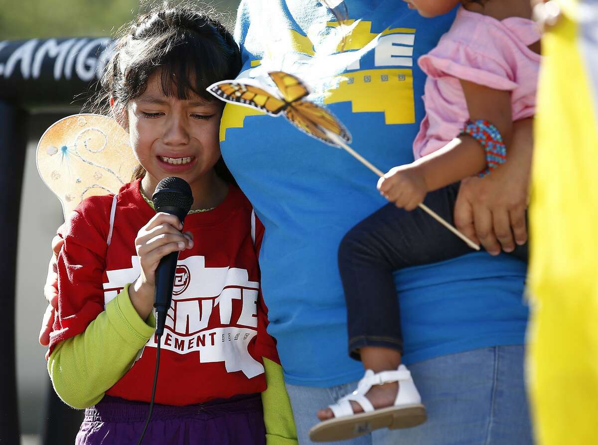 Akemi Vargas, 8, cries as she talks about being separated from her father during an immigration family separation protest in front of the Sandra Day O'Connor U.S. District Court building, Monday, June 18, 2018, in Phoenix. An unapologetic President Donald Trump defended his administration's border-protection policies Monday in the face of rising national outrage over the forced separation of migrant children from their parents. (AP Photo/Ross D. Franklin)