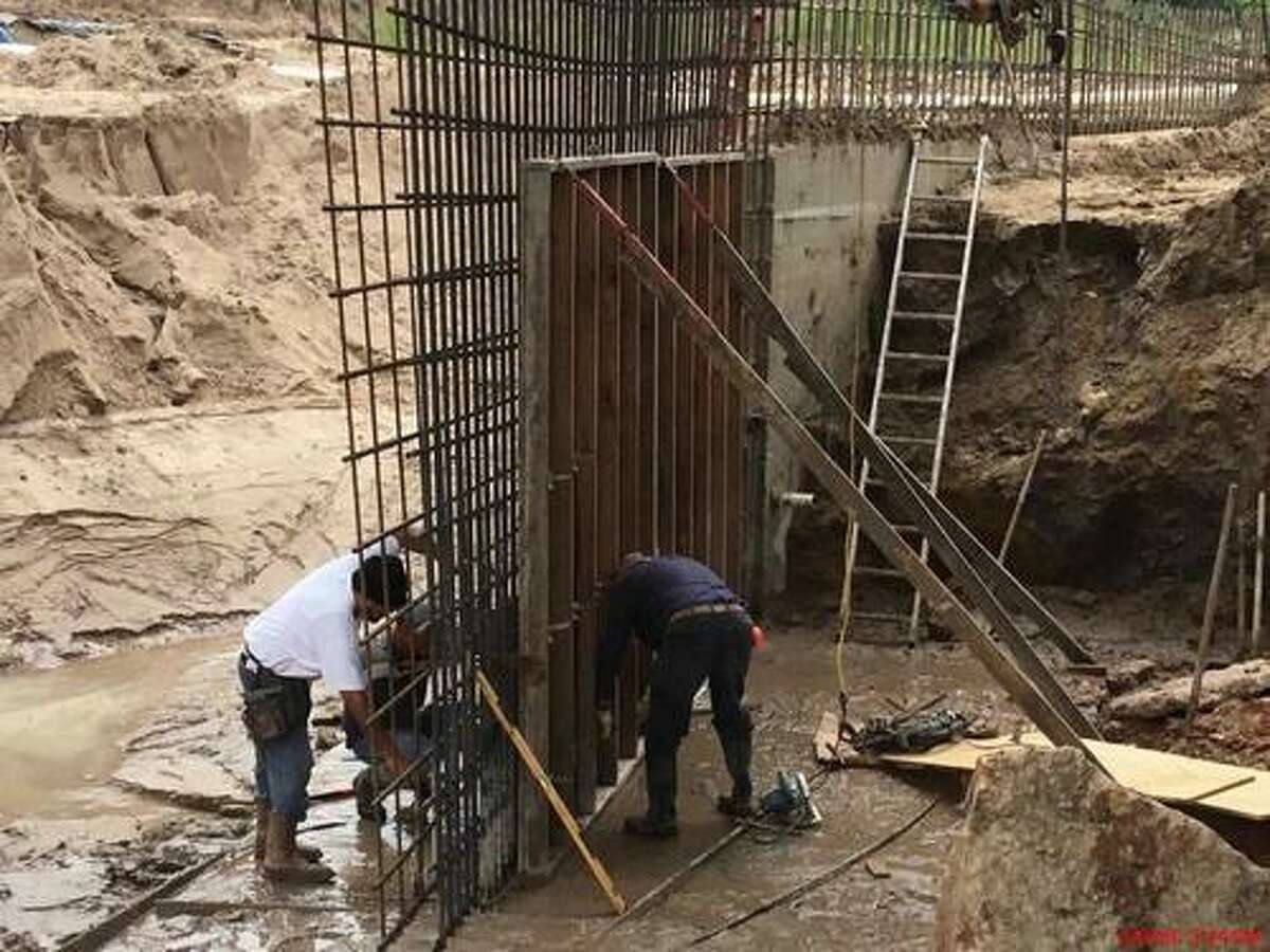 Crews work on a concrete wall that will replace the wooden bulkhead underneath Buffalo Springs Bridge. The wall will hold the slopes up and back to prevent future erosion and problems seen during May 2016 flooding, according to Jones and Carter Project Engineer for the city of Montgomery Chris Roznovsky.
