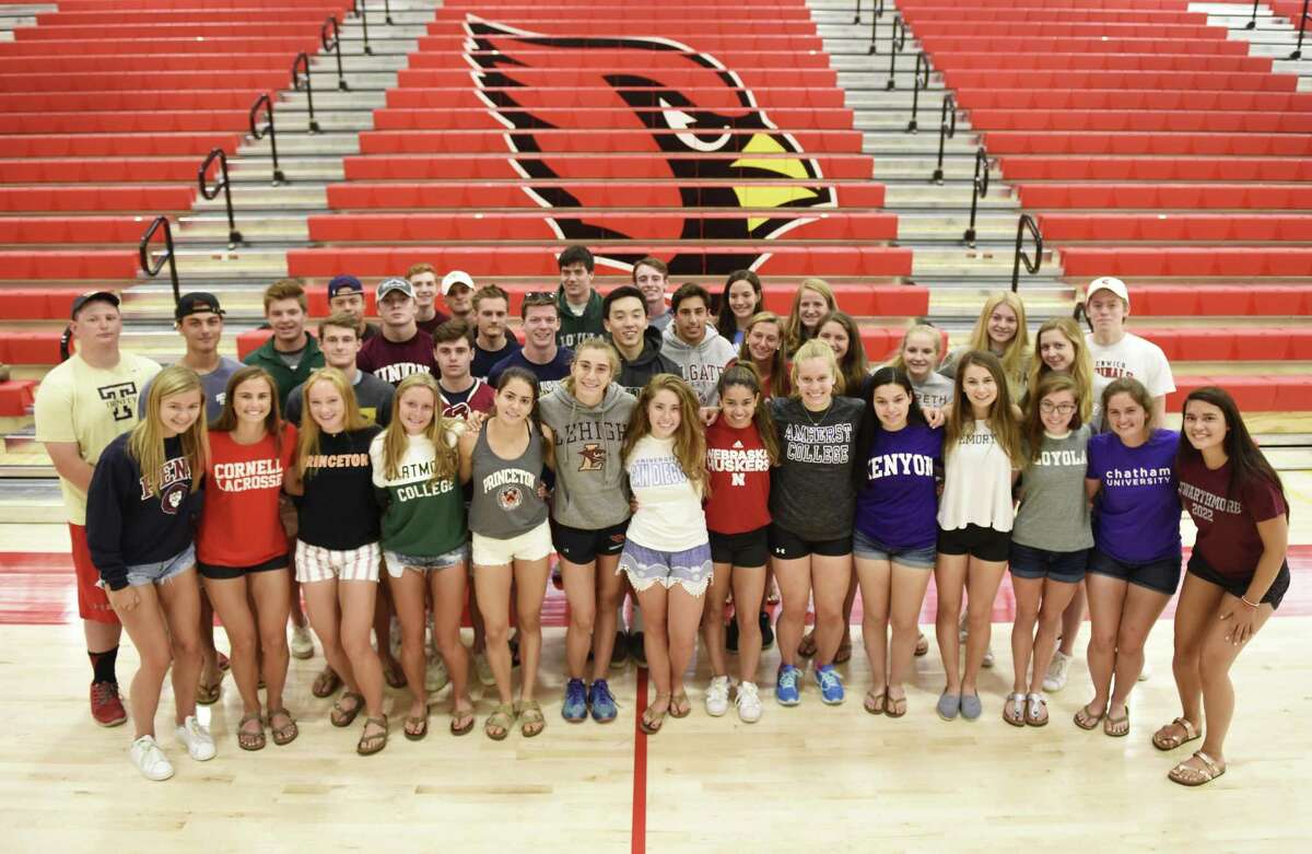 Greenwich High school senior athletes who received scholarships to play at the collegiate level pose in the gym at Greenwich High School on Tuesday.