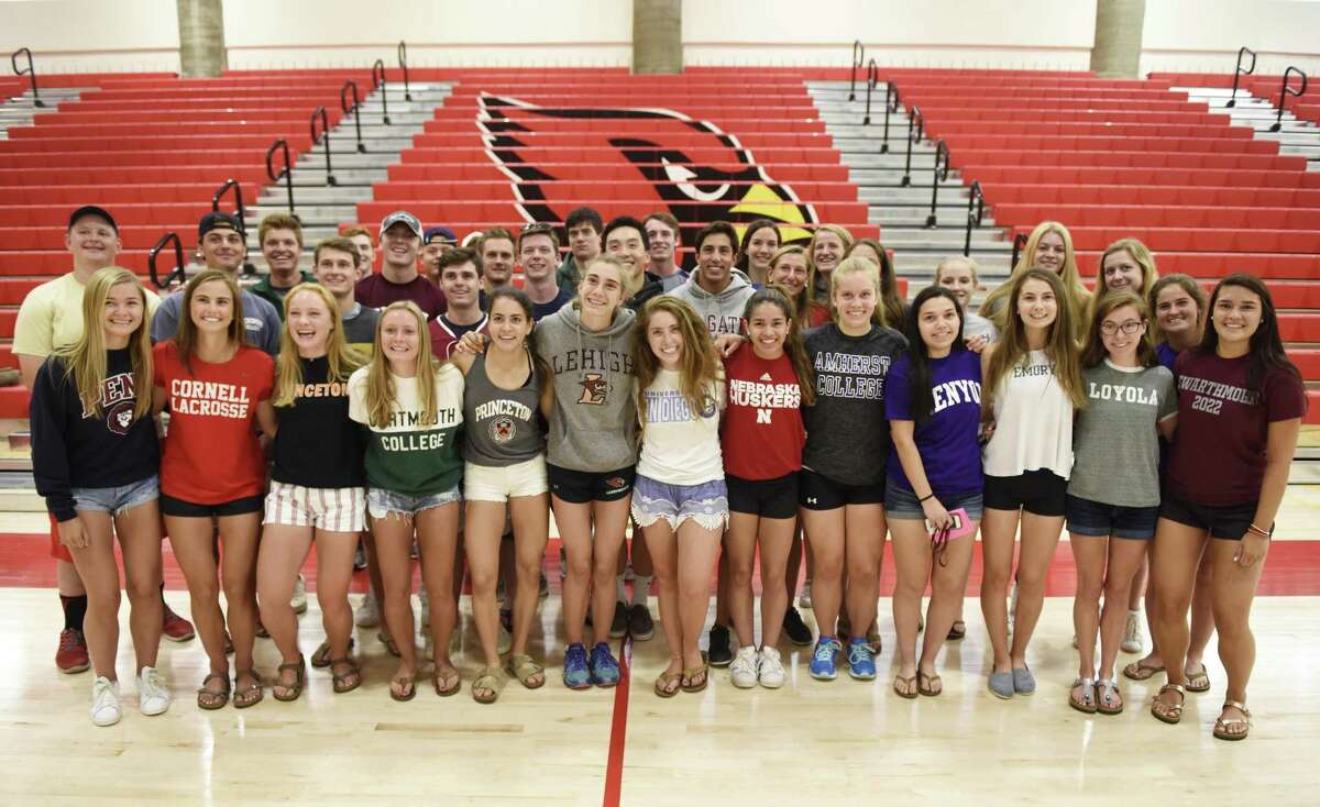 High school senior athletes who received scholarships to play at the collegiate level pose in the gym at Greenwich High School in Greenwich, Conn. Tuesday, June 19, 2018.