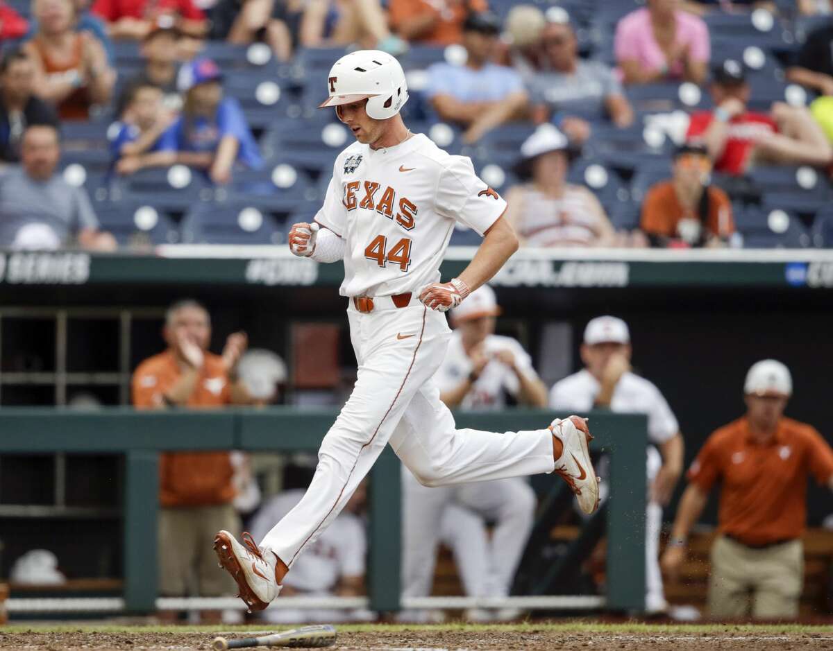 Texas' Austin Todd (44) scores on a single by DJ Petrinsky (6) in the eighth inning of an NCAA College World Series baseball elimination game in Omaha, Neb., Tuesday, June 19, 2018. Florida won 6-1. (AP Photo/Nati Harnik)