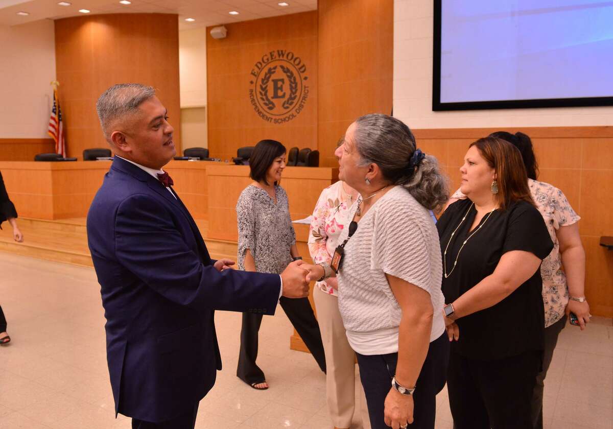 Eduardo Hernandez, the incoming superintendent of Edgewood ISD, greets well-wishers during the executive session of Wednesday’s board meeting.