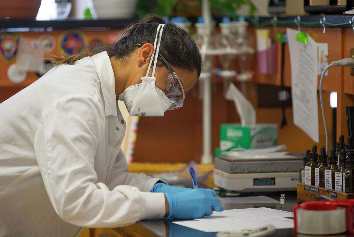 Forensic analyst Stephanie Galioto makes an initial assessment of a white powder inside the lab at the Houston Forensic Science Center inside the Houston Police Department headquarters building, Tuesday, June 19, 2018 in downtown Houston. The presumptive test indicated the presence of cocaine. The sample will then move on to a GCMS instrument that will be used to possibly confirm the results.