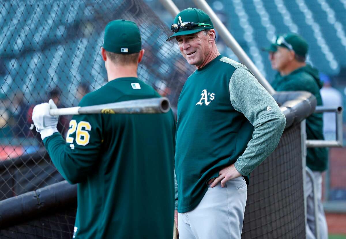Oakland Athletics' manager Bob Melvin chats with Matt Chapman before the A's play San Francisco Giants during Bay Bridge Series game at AT&T Park in San Francisco, Calif., on Monday, March 26, 2018.