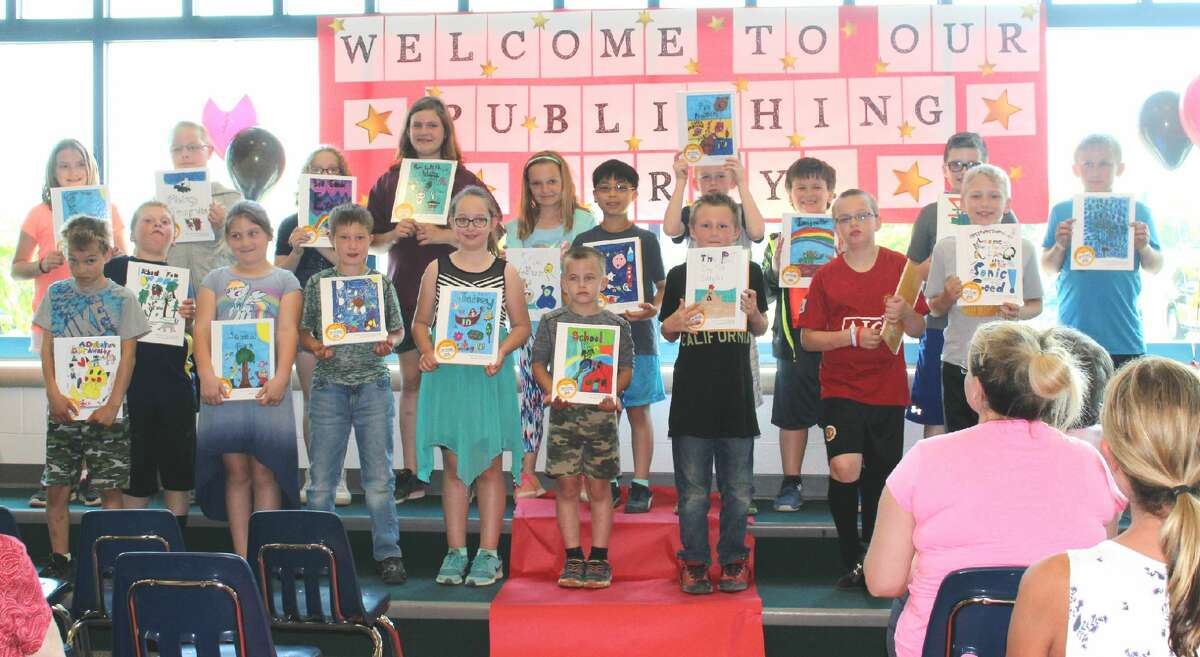 Laker third graders in Amy Smithers' class show the books they had published. Each student wrote nine short stories for their book and illustrated each story. The students also designed the covers of their books. A party celebrating their published books was conducted at the school library, and parents and family members were invited to attend.