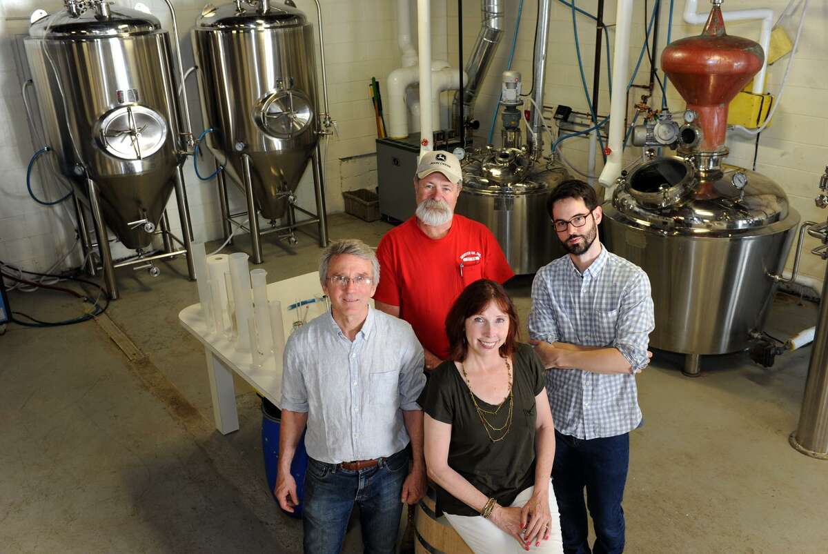 Robert and Bridget Schulten, front, and their business partners Gary Griffith and Neil Doocy at Asylum Distillery, in Bridgeport, Conn. June 2, 2016