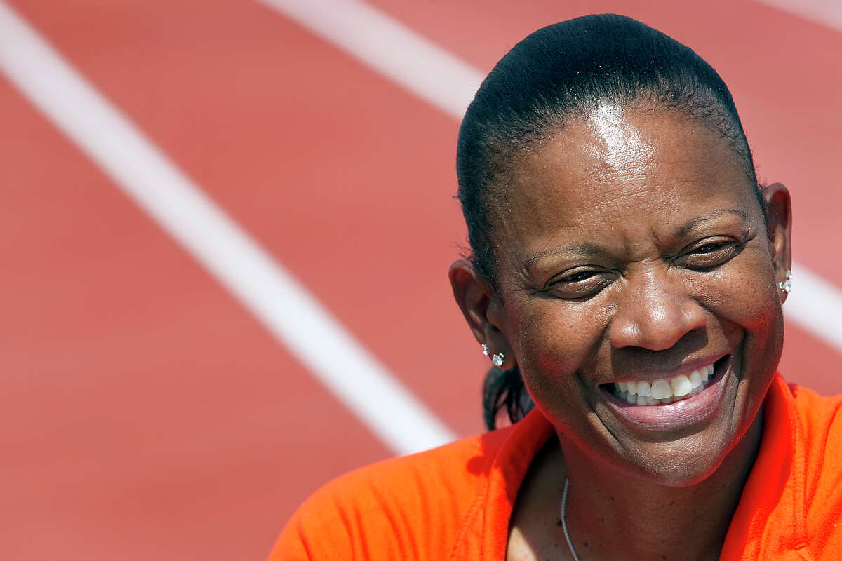 FILE - In this March 31, 2011, file photo, Texas women's head track and field coach Beverly Kearney smiles during practice in Austin, Texas. The Texas Supreme Court has refused to block a sex and race discrimination lawsuit filed against the University of Texas by former women's track coach Bev Kearney, who was forced out after the school learned of a romantic relationship with one of her athletes a decade earlier. (Ralph Barrera/American-Statesman via AP, File)