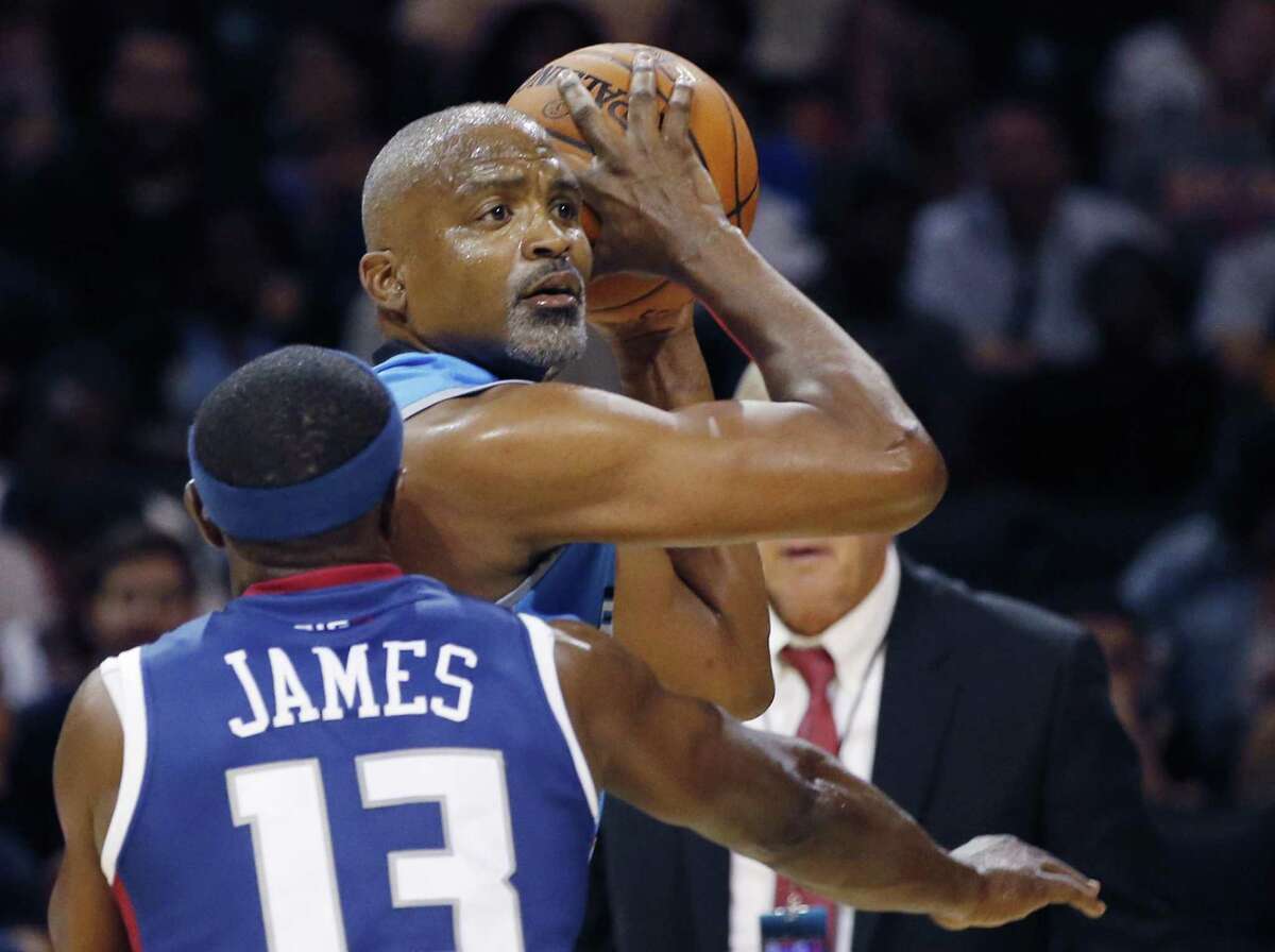 Power player/captain Cuttino Mobley, top, looks to pass as Tri-State's Mike James (13) defends during the first half of Game 2 in the BIG3 Basketball League debut, Sunday, June 25, 2017, at the Barclays Center in New York. (AP Photo/Kathy Willens)
