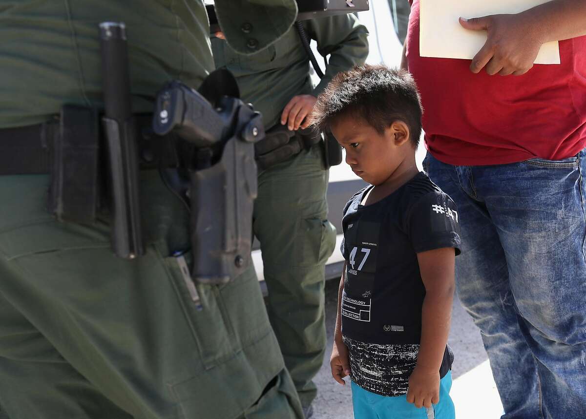 MISSION, TX - JUNE 12: A boy and father from Honduras are taken into custody by U.S. Border Patrol agents near the U.S.-Mexico Border on June 12, 2018 near Mission, Texas. The asylum seekers were then sent to a U.S. Customs and Border Protection (CBP) processing center for possible separation. U.S. border authorities are executing the Trump administration's 'zero tolerance' policy towards undocumented immigrants. U.S. Attorney General Jeff Sessions also said that domestic and gang violence in immigrants' country of origin would no longer qualify them for political asylum status.