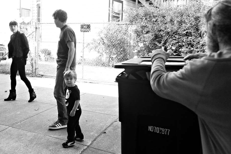 Laszlo Diamond  (second from right) looks back at a man looking in a garbage bin while walking along 13th Street with his mother Jill Diamond (left) and father Ernst Schoen-Rene (second from left), and Laszlo Diamond walk along 13th Street  on Monday, April 23, 2018 in San Francisco, Calif. Photo: Lea Suzuki / The Chronicle