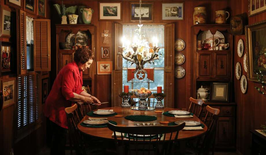 Betty Oglesbee sets the table before her son and daughter-in-law arrive for dinner at her home in San Augustine. Among other dishes, she planned to serve meatloaf, potatoes and fried green tomatoes. Photo: Michael Ciaglo