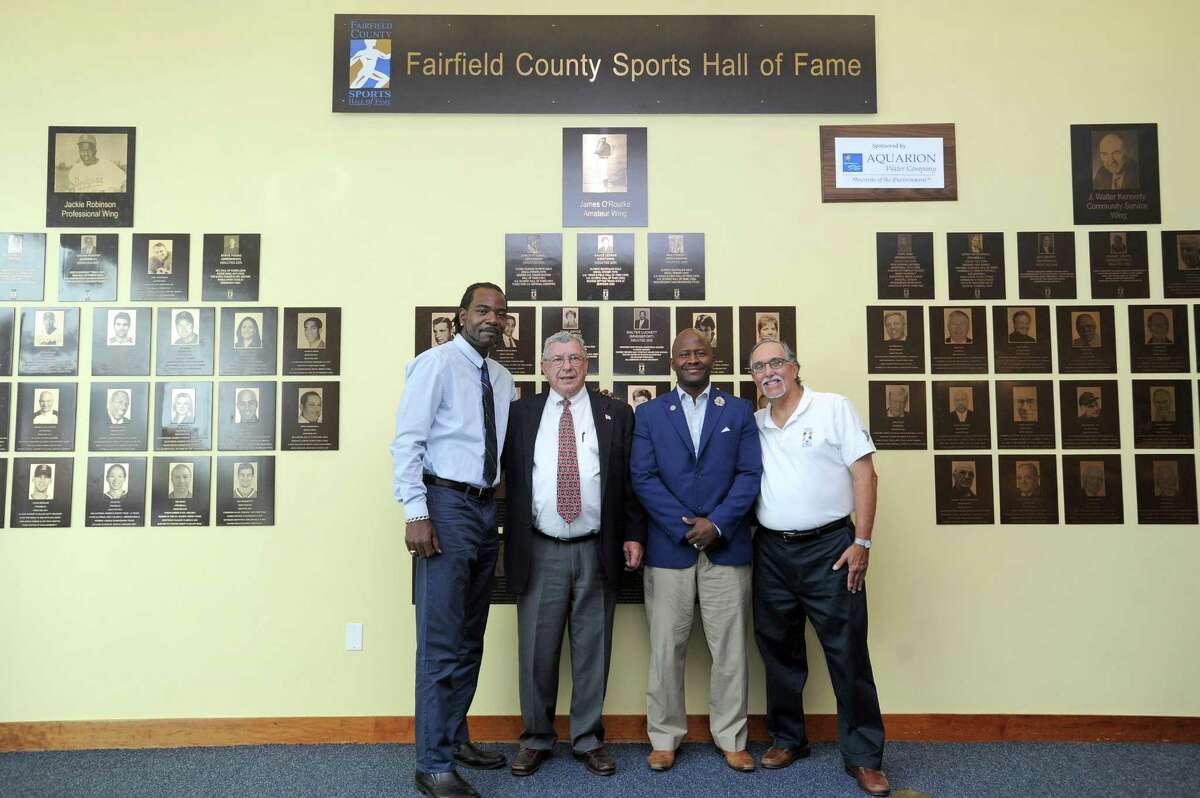 From left, Rashamel Jones, John Kuczo, Travis Simms and Fairfield County Sports Commission executive director Tom Chiappetta pose for a photo following the ceremony announcing the 2018 inductees to the Fairfield County Sports Hall of Fame inside UConn Stamford in downtown Stamford, Conn. on Wednesday, June 20, 2018.