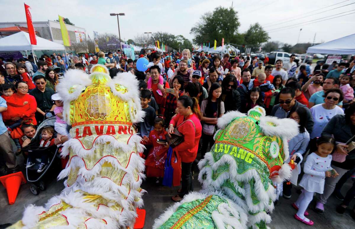 A crowd forms around the Lavang Lion Dance Team during a Lunar New Year celebration at the Chinese Community Center on Saturday, Feb. 17, 2018, in Houston.