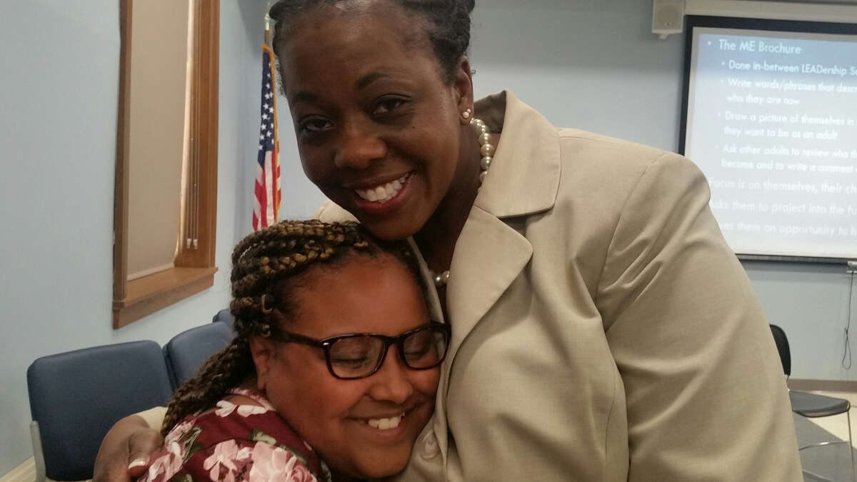 Thomas O'Brien Academy of Science & Technology 5th grader Aaliyah Milgo, 10, gets a congratulatory hug from Albany City School District Superintendent Kaweeda G. Adams. (Lynda Edwards/ Times Union)