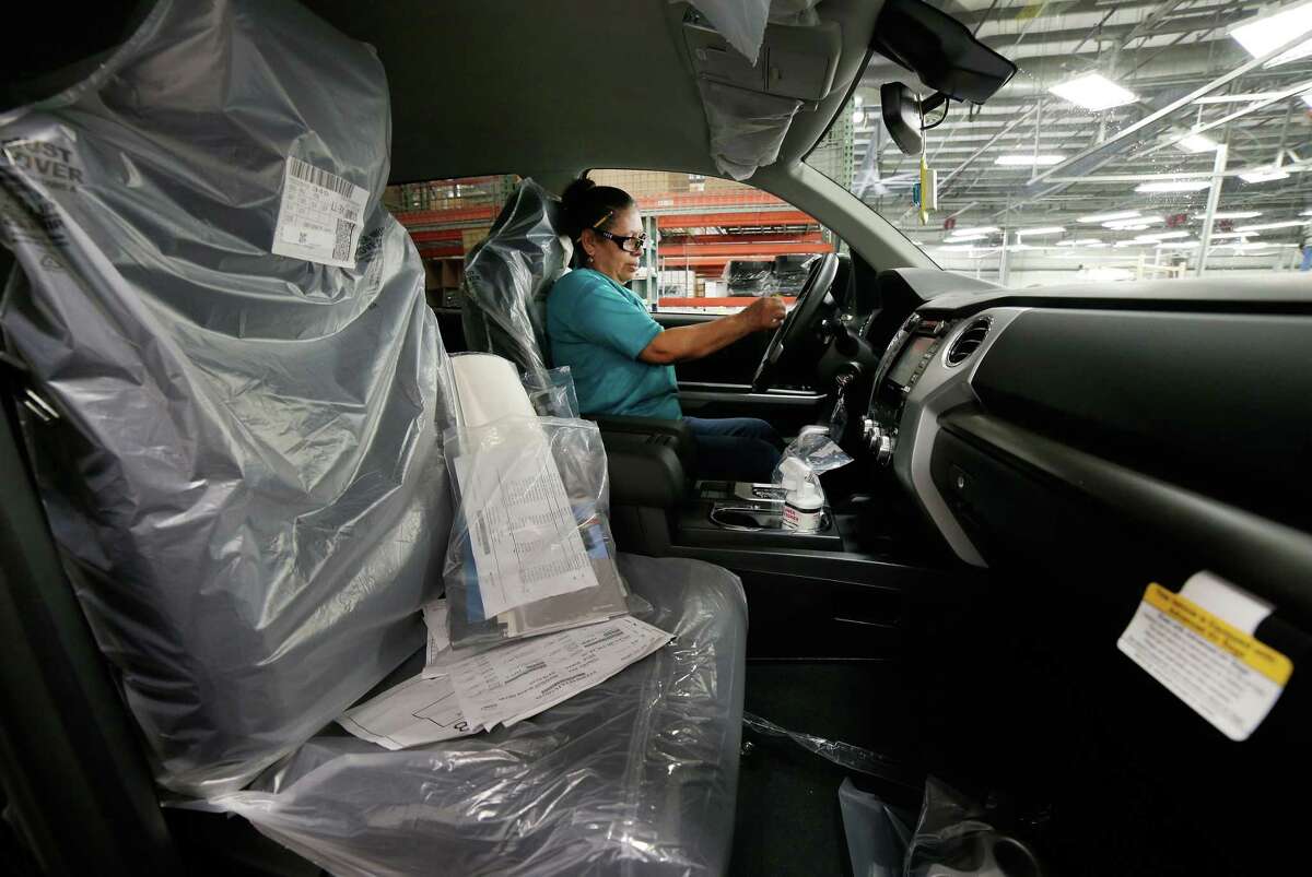 Maria Mendoza Cisneros drives a new pick up truck to the next station after installing small accessories before it is shipped to a dealership at the Gulf States Toyota vehicle processing facility Wednesday, May 23, 2018, in Houston, TX. The facility averages around 6000 Toyota vehicles on the lot at anytime being prepped and processed before being sent to Toyota dealerships. (Michael Wyke / For the Chronicle)