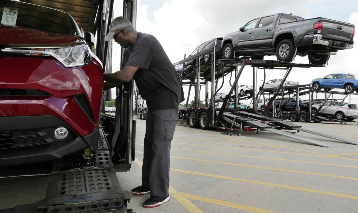 Driver John Massenburg secures Toyota vehicles to a car hauler to take to dealerships at the Gulf States Toyota vehicle processing facility Wednesday, May 23, 2018, in Houston, TX. The facility averages around 6000 Toyota vehicles on the lot at anytime being prepped and processed before being sent to Toyota dealerships. (Michael Wyke / For the Chronicle)