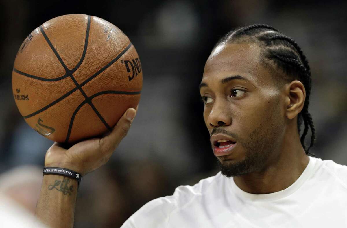 FILE - In this Jan. 5, 2018, file photo, San Antonio Spurs forward Kawhi Leonard handles a ball before an NBA basketball game against the Phoenix Suns in San Antonio. A person familiar with the situation tells The Associated Press, Friday, June 15, 2018, that Leonard has told the Spurs that he would like to be traded this summer, the clearest sign yet that the relationship between the team and the All-Star is in disrepair. (AP Photo/Eric Gay, File)